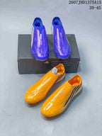 Purple and yellow adidas F50 Elite football boots shown together from above with a black shoebox.