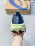 Rear view showing the padded heel collar, pull tab, central heel detail and lime-colored midsole.