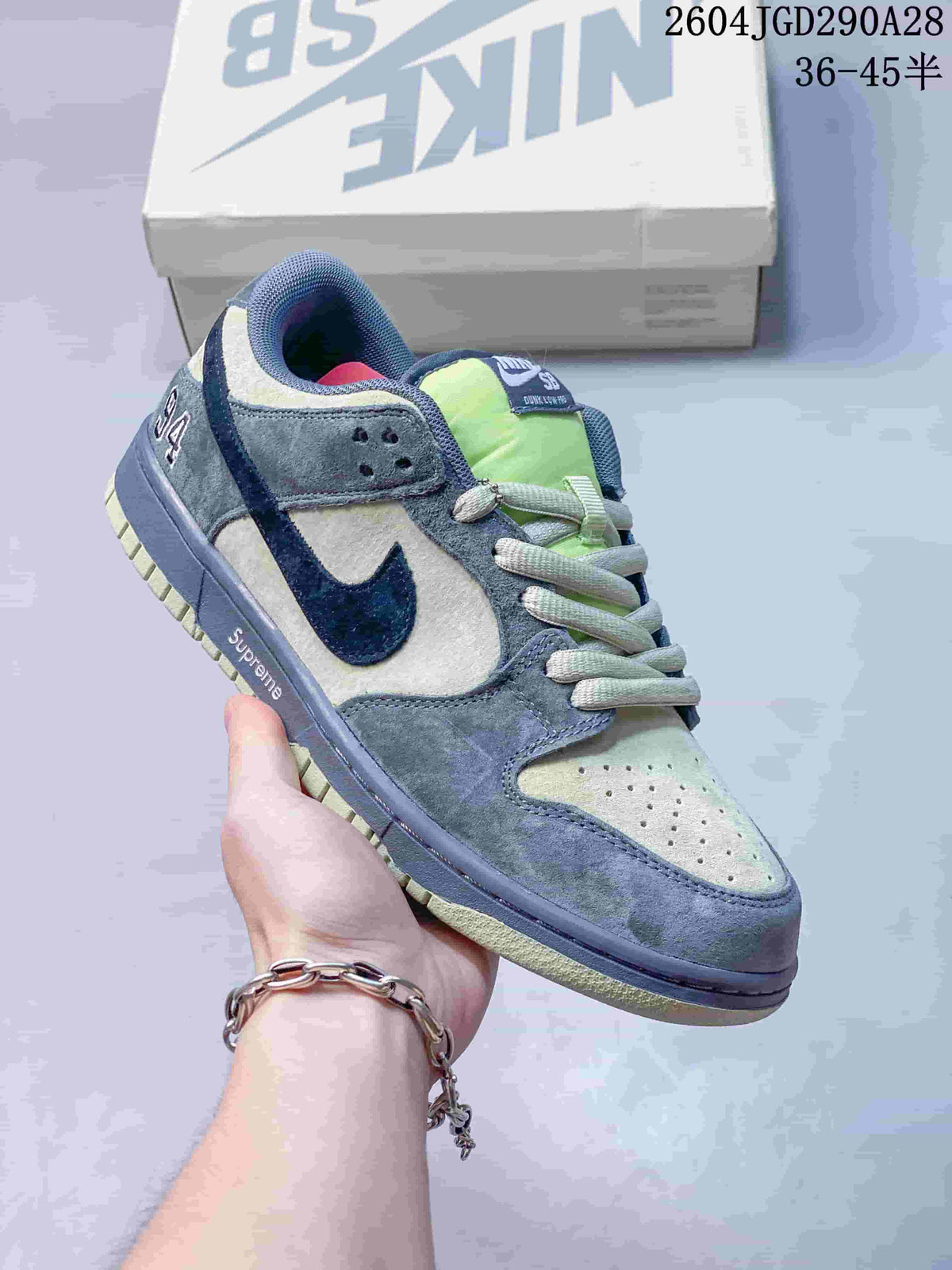 Gray and pale green Nike Dunk Low sneaker with navy accents; image overlay shows sizes 36–45.5.