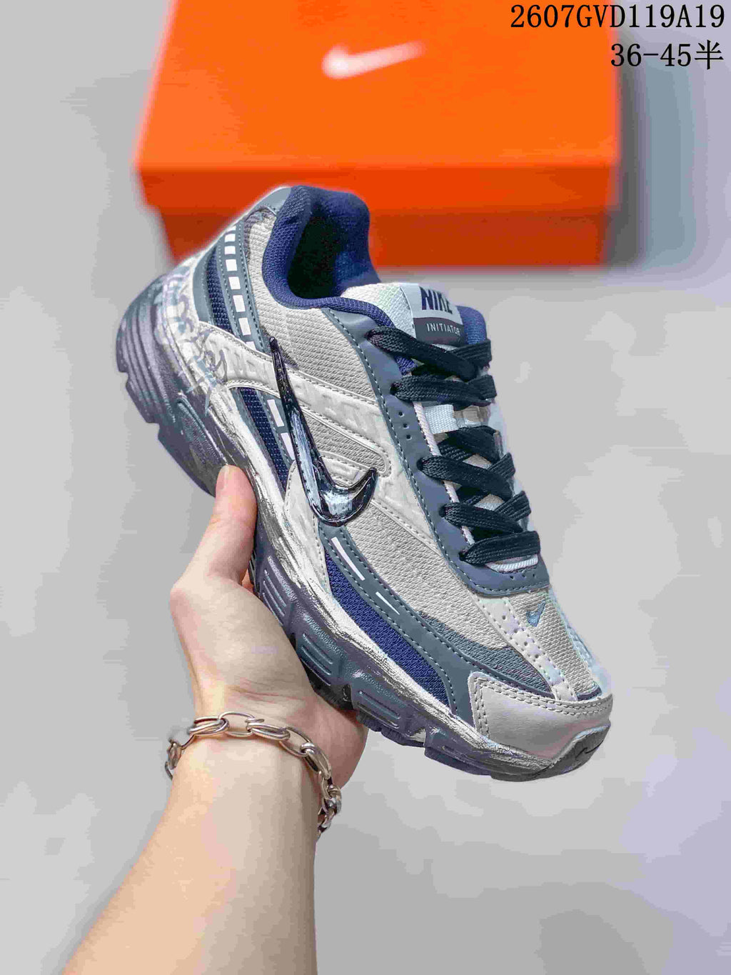 Angled side view of the black, grey and white Nike Initiator sneaker.