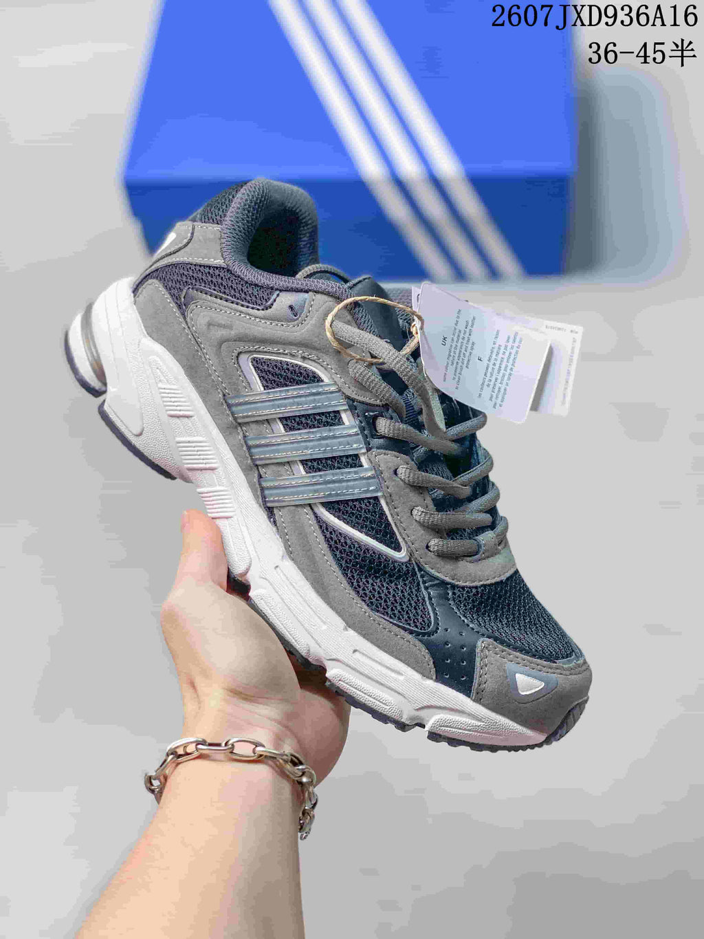Gray adidas Response CL sneaker with darker mesh panels, silver-toned side stripes, and a white sole.