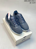 Pair of dark gray Nike SB low-top shoes displayed on a shoebox, with Nike SB branding and a translucent outsole.