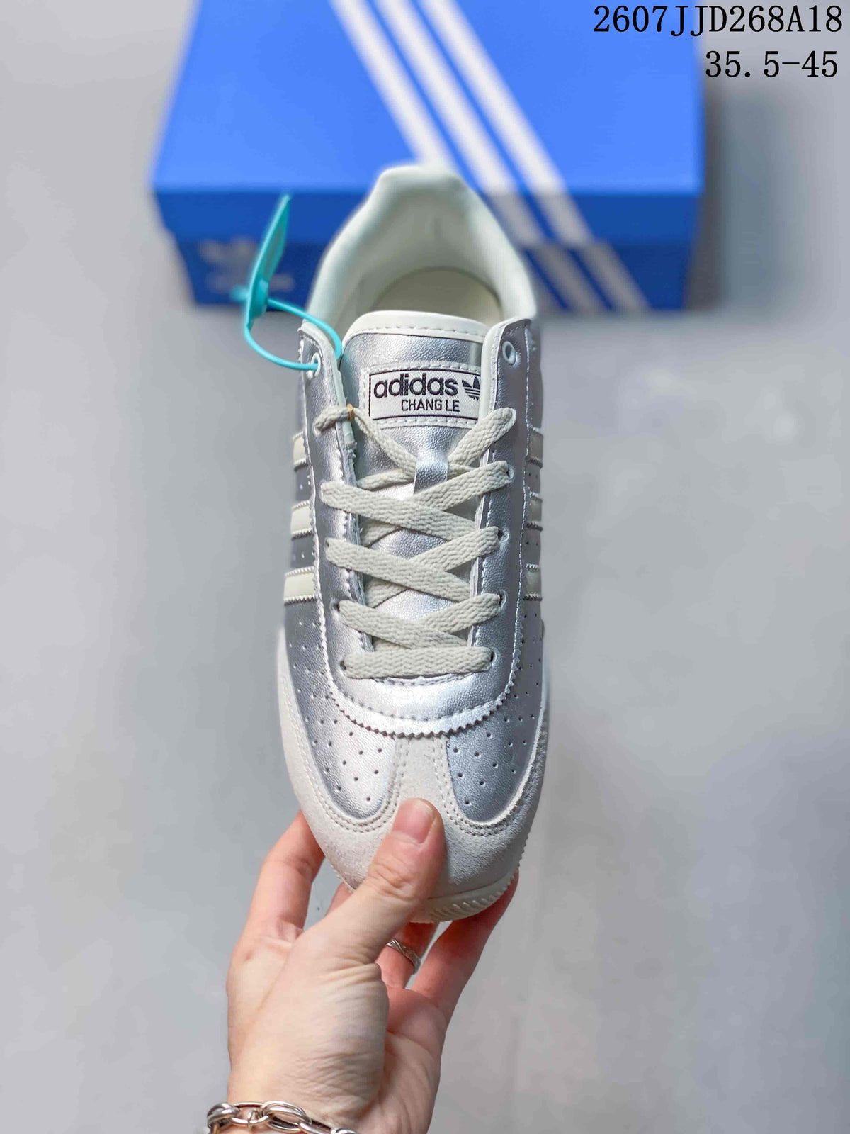 Top view of the sneaker showing the perforated toe, white laces, padded tongue, and contrast panels.