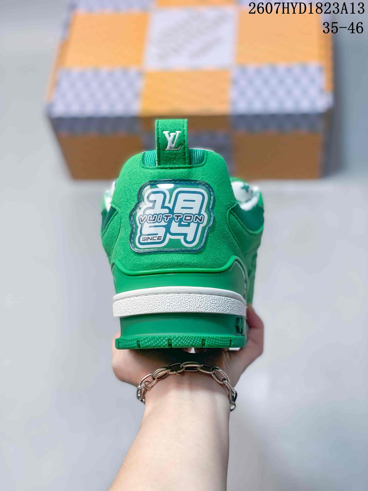 Rear view of the green sneaker showing the branded heel patch, white midsole and green heel pull tab.