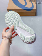 Close view of the ASICS running shoe outsole showing segmented traction sections and grooves.