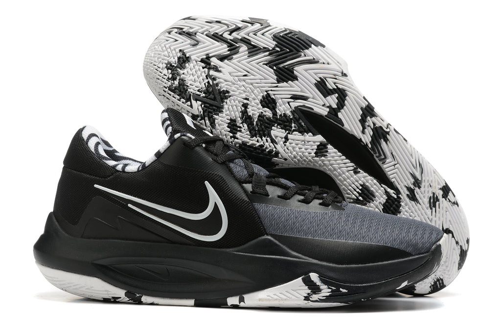 Black and gray basketball shoe with a black-and-white patterned outsole.