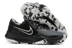 Black and gray basketball shoe with a black-and-white patterned outsole.