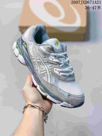 Three-quarter side view of the gray and white sneaker showing the layered upper, lime-green side branding and sculpted sole.