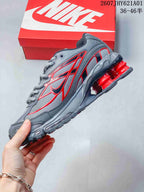 Side view of the grey and red Nike Shox Ride 2 sneaker
