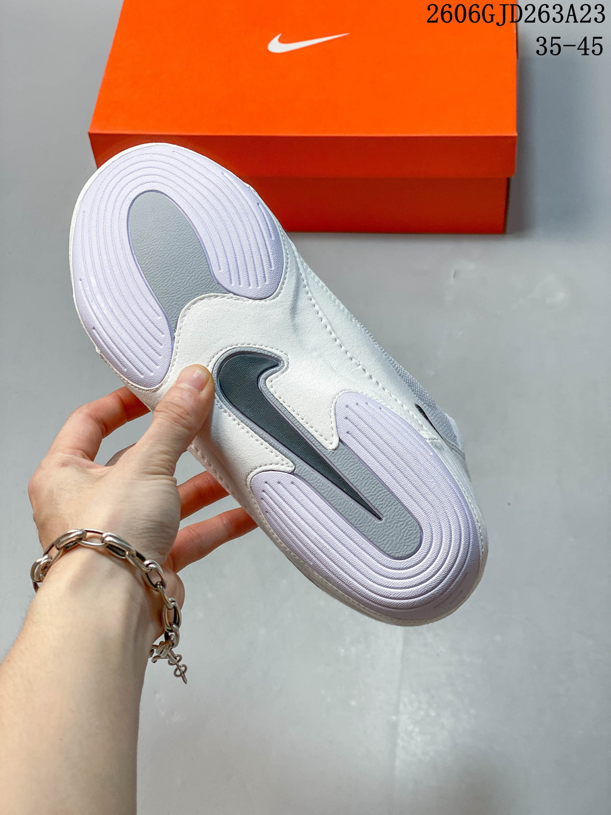 Outsole of a white Nike Inflict 4 wrestling shoe showing the tread and Swoosh detail.