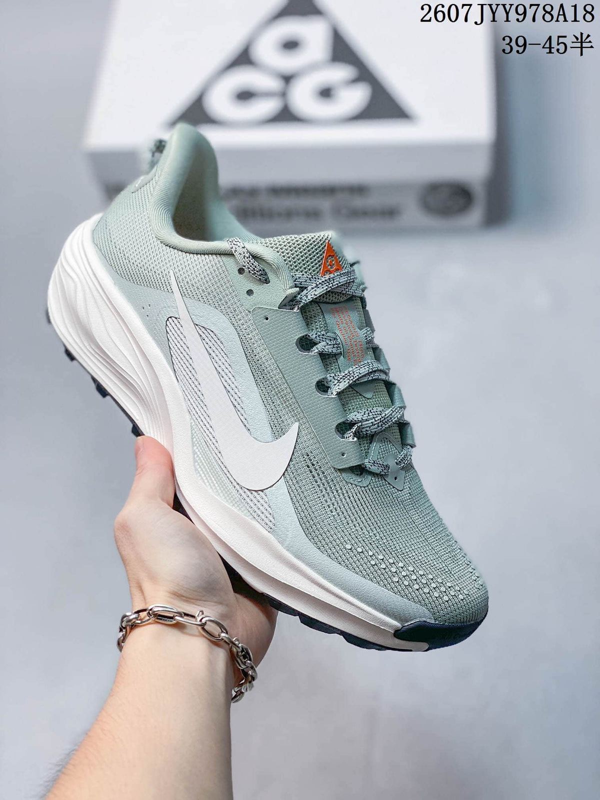 Pale green Nike ACG Pegasus Trail sneaker shown from the side with a light midsole and dark outsole.
