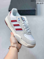 Angled side view of the white adidas Originals sneaker with red and light blue side accents.