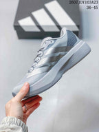 Side profile of the light gray and white low-top running shoe showing the layered adidas stripes and raised midsole.
