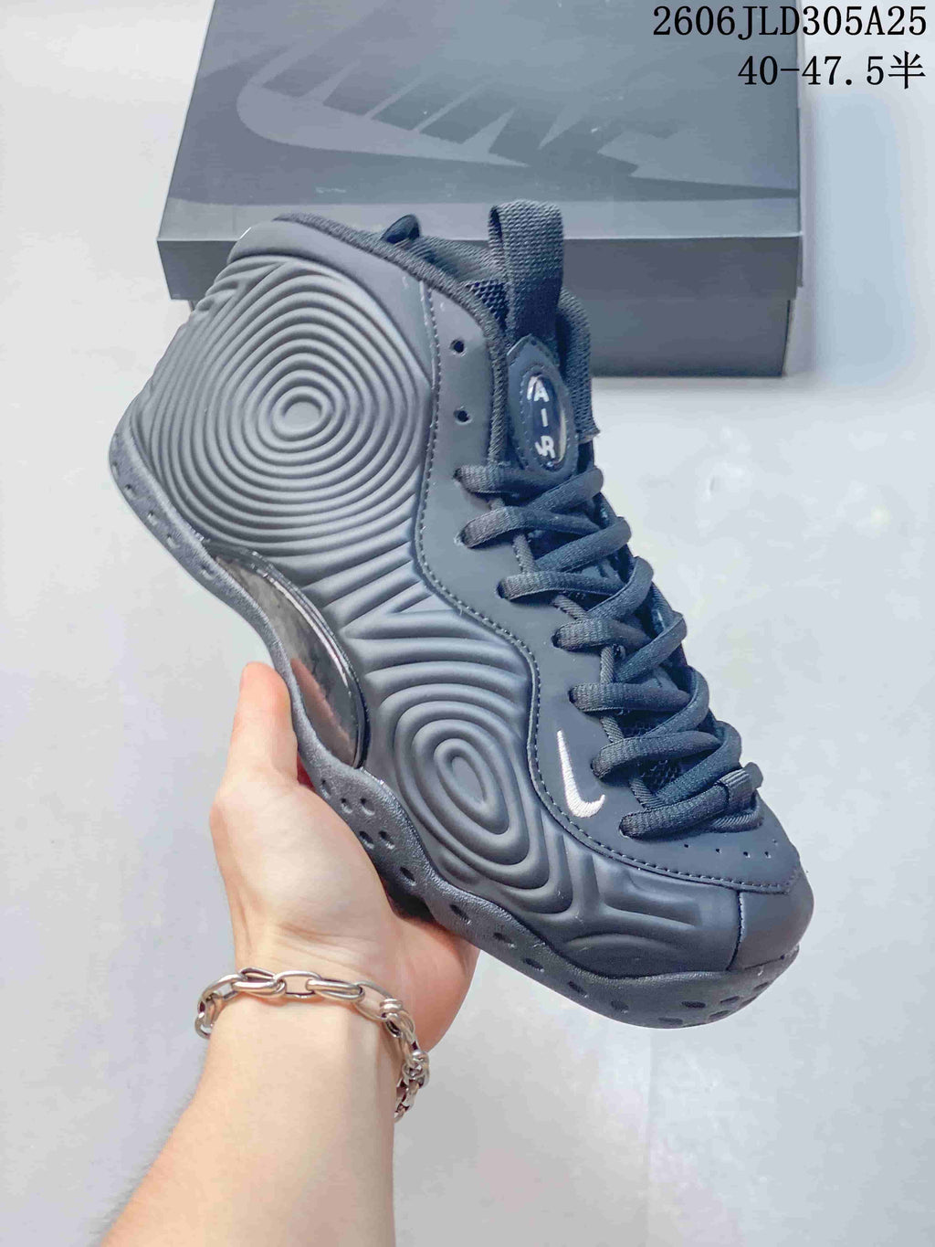 Angled side view of the gray high-top shoe and its sculpted panels