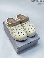Pair of off-white clog sandals with contrasting brown heel straps, shown from above on a shoebox.