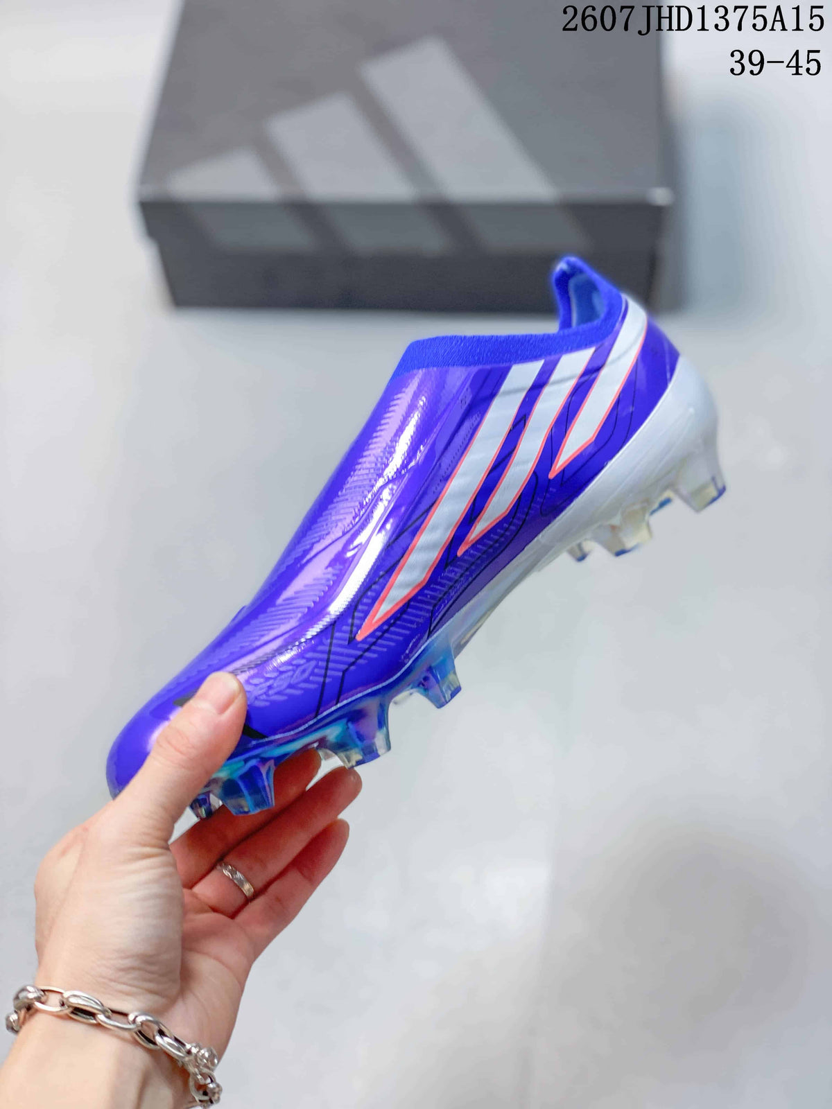 Side view of a purple adidas F50 soccer cleat showing the three stripes, streamlined upper, and studded outsole.
