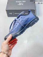 Side view of the blue and dark gray low-cut lace-up shoe