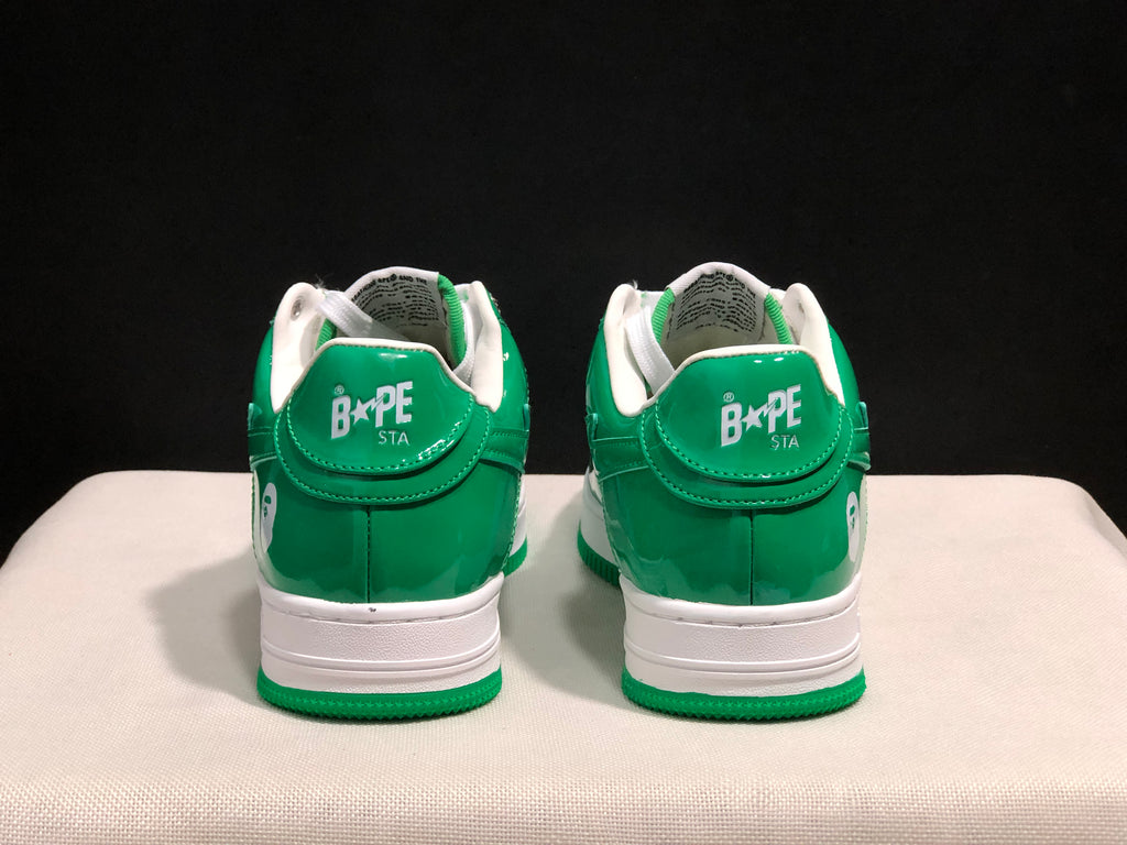 Rear view of the pair showing green heels, white BAPE STA branding, and white midsoles.