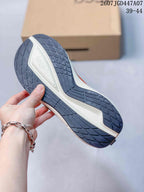 Underside view of an ECCO sneaker showing the segmented dark outsole tread and light midsole section.
