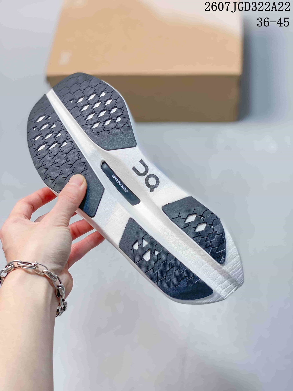 Underside of the shoe showing a segmented black-and-white outsole with textured traction and a visible SPEEDBOARD marking.