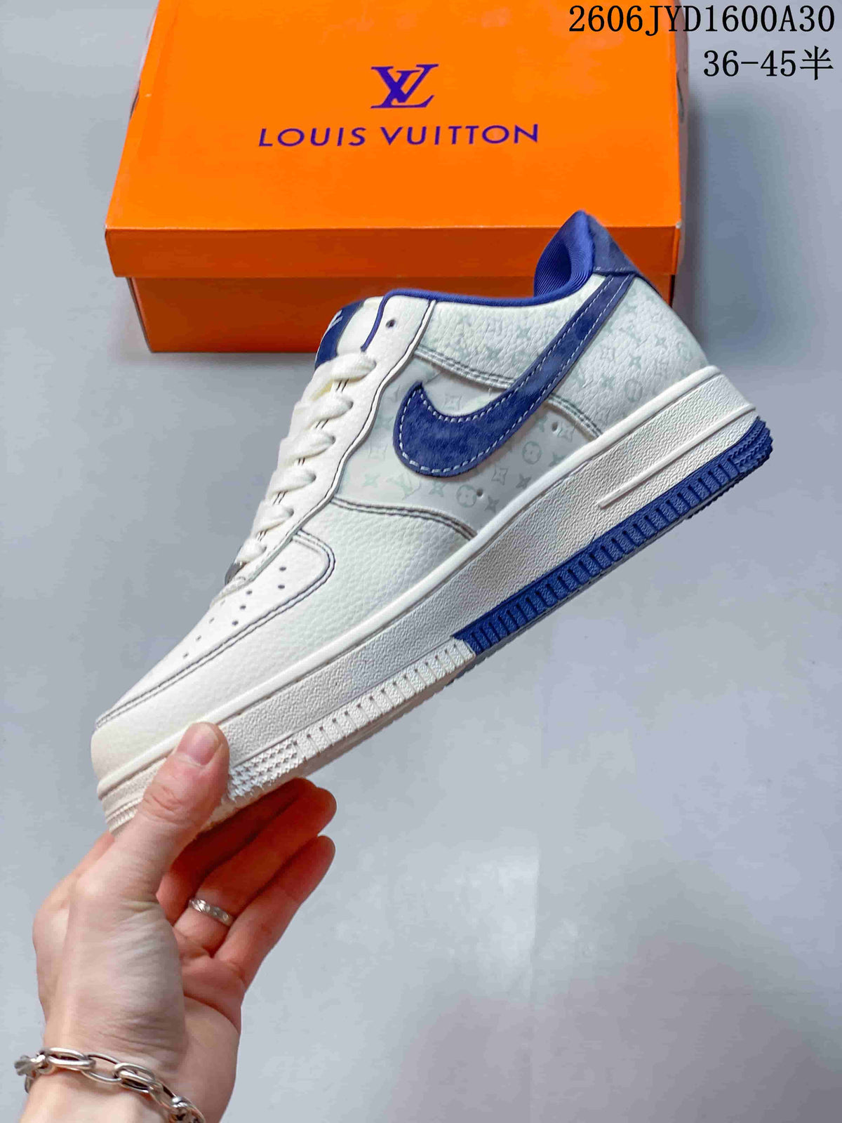 Side view of a white low-top sneaker with blue accents and patterned panels