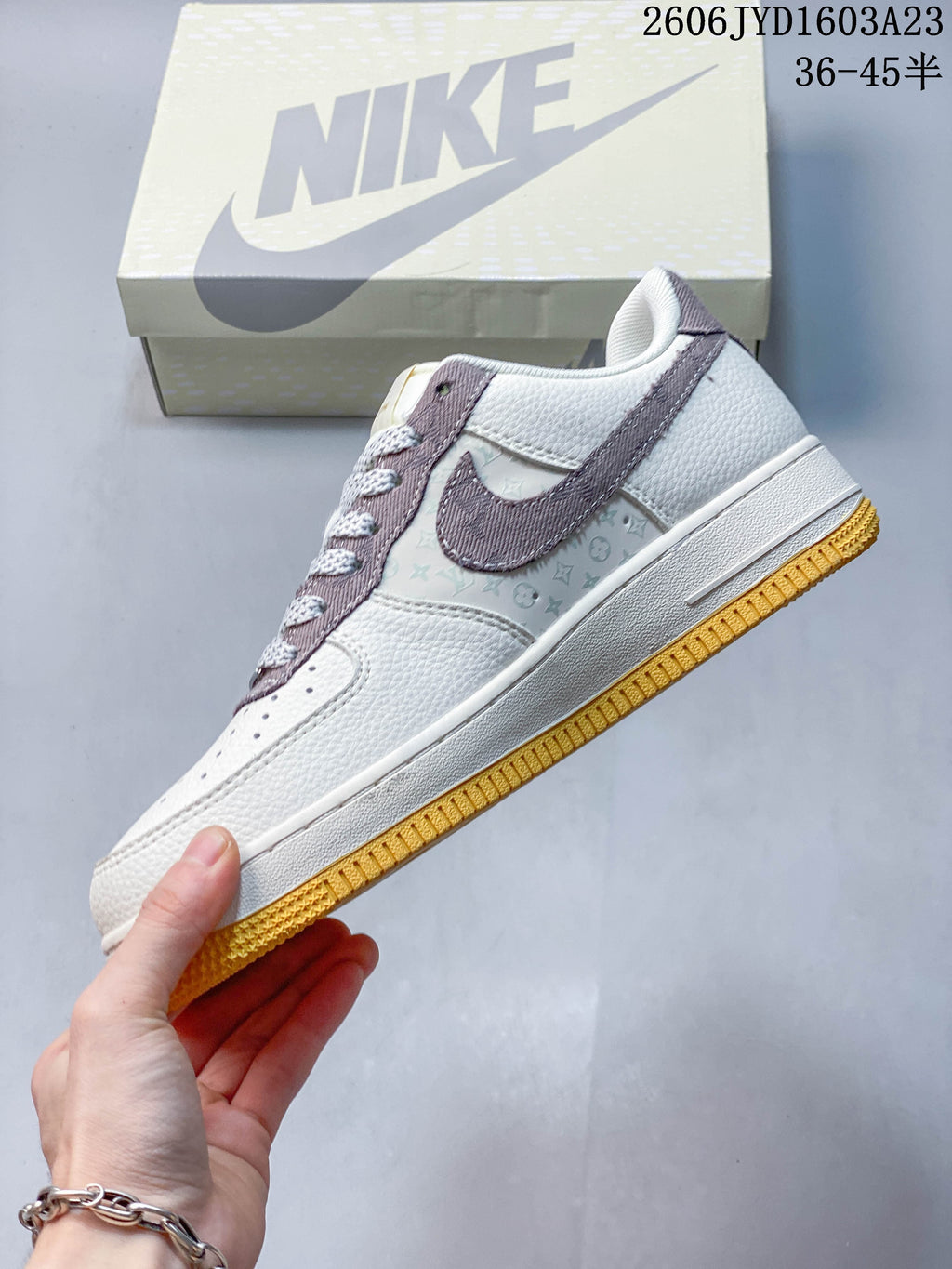 Side view of the low-top sneaker with mauve overlay, patterned side panel, and gum-yellow outsole.
