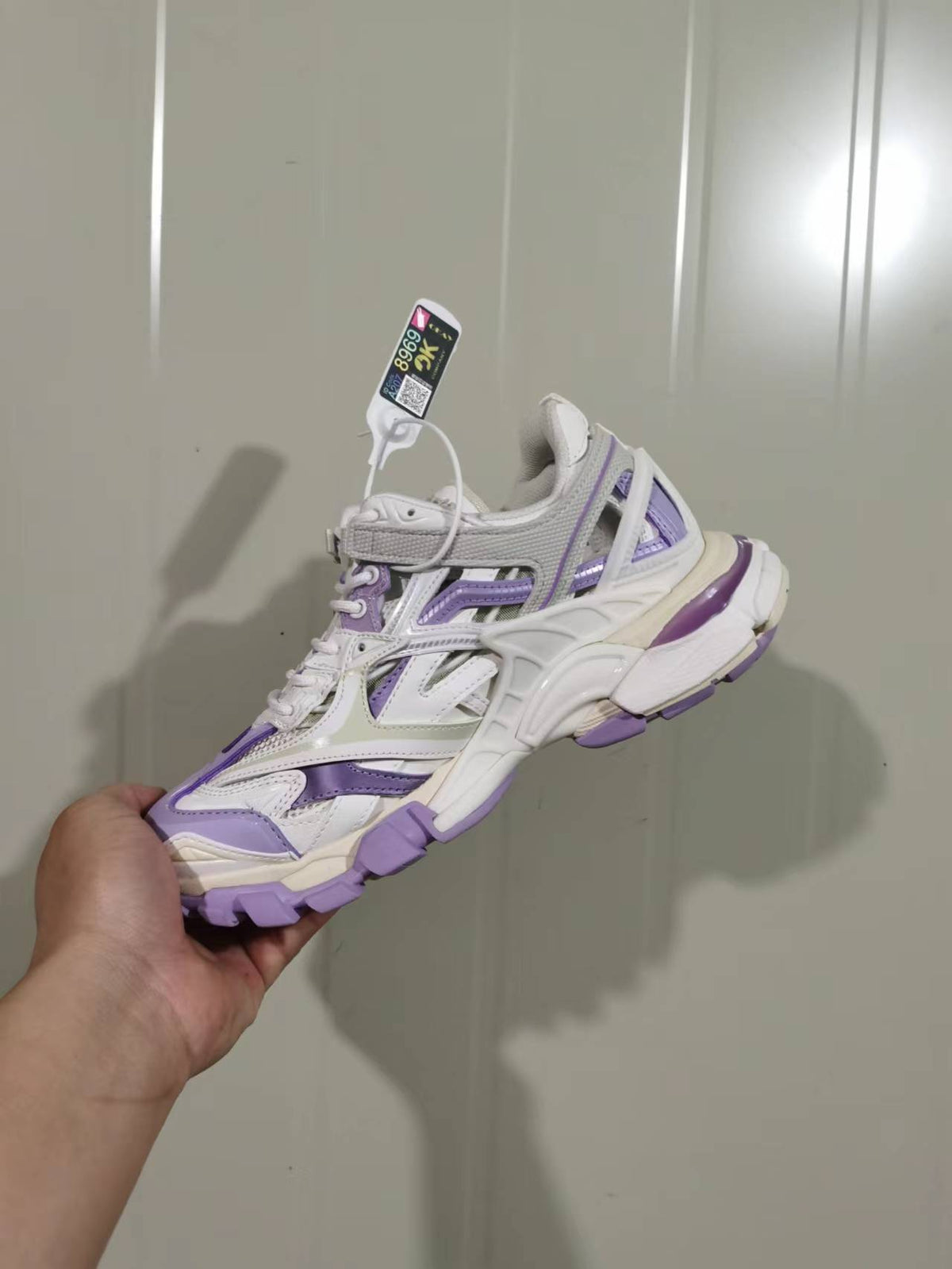 Side view of the lilac, beige and grey Balenciaga Track 2.0 open sneaker showing layered panels and a chunky outsole.