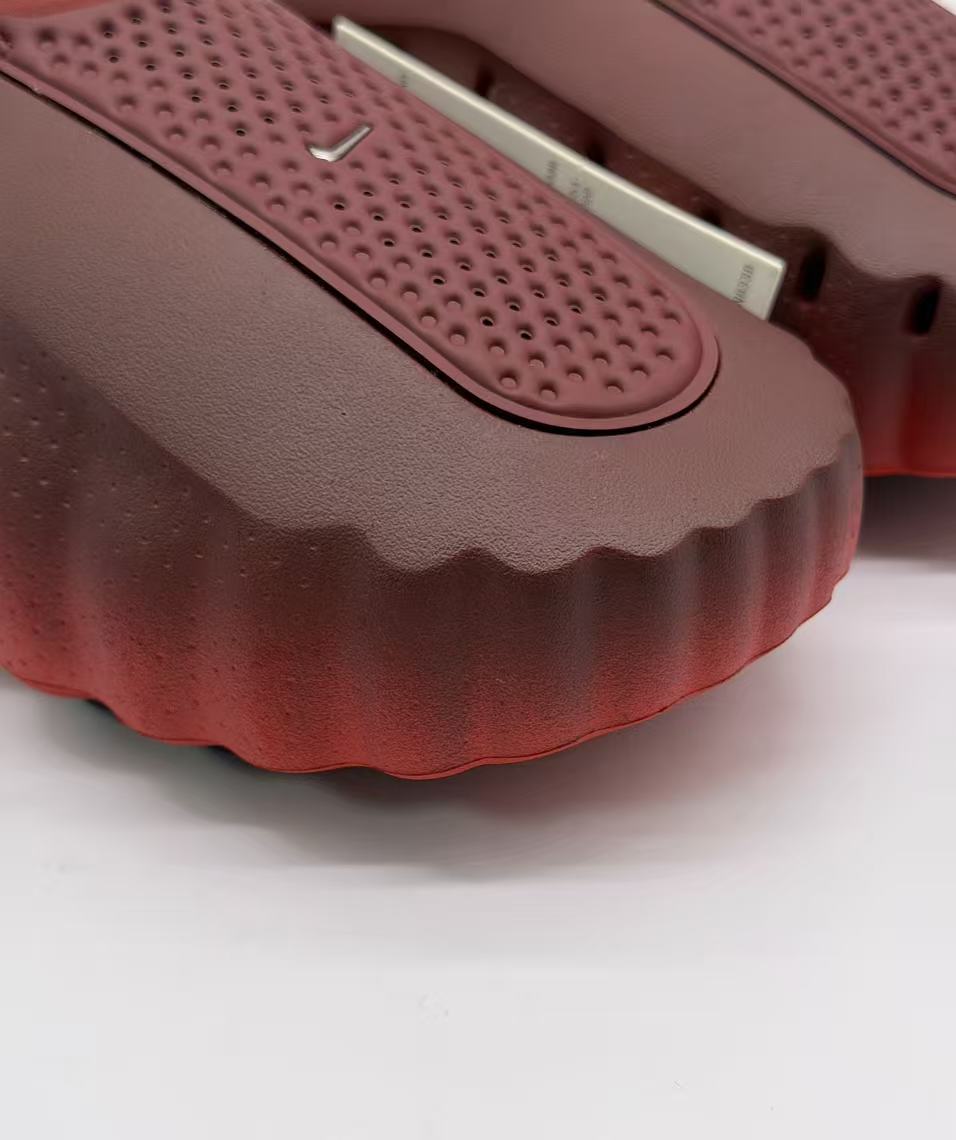 Close-up of the perforated textured footbed panel and scalloped front edge.