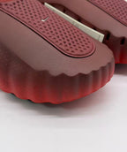 Close-up of the perforated textured footbed panel and scalloped front edge.