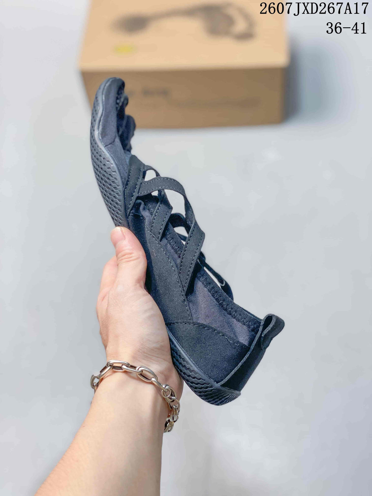 Side view highlighting the low-profile shape, crossover straps, and individual toe construction.