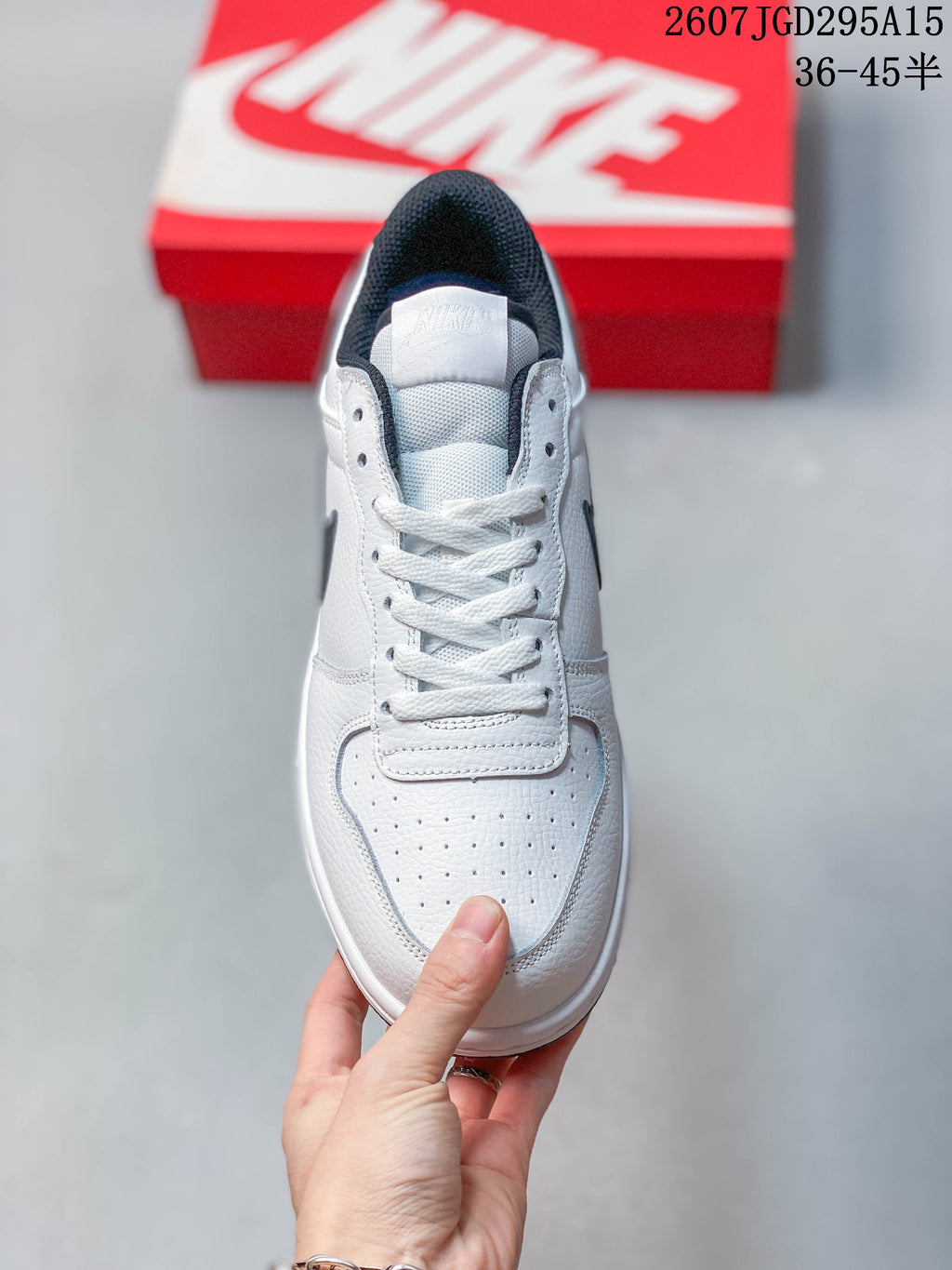 Top view showing the white perforated toe box, white laces, tongue, and black collar lining.