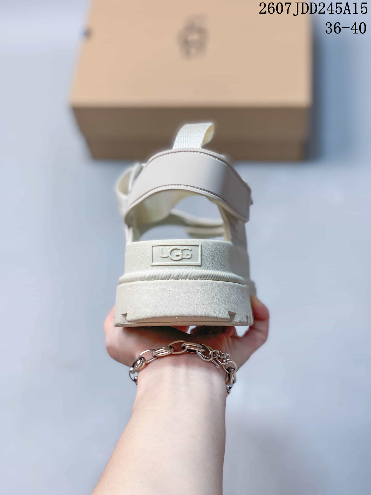 Rear view of the light white sandal showing the ankle strap, heel branding, and raised platform sole.