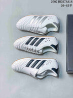 Three views of the white adidas sneakers showing the dark side stripes, lace-up construction, tongue covers and gum-colored outsoles.