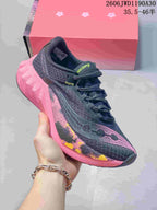 Charcoal Saucony running shoe with pink sculpted sole and patterned side detail