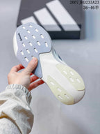 Close-up of the sneaker outsole showing contrasting gray and translucent sections with elongated cutout details.