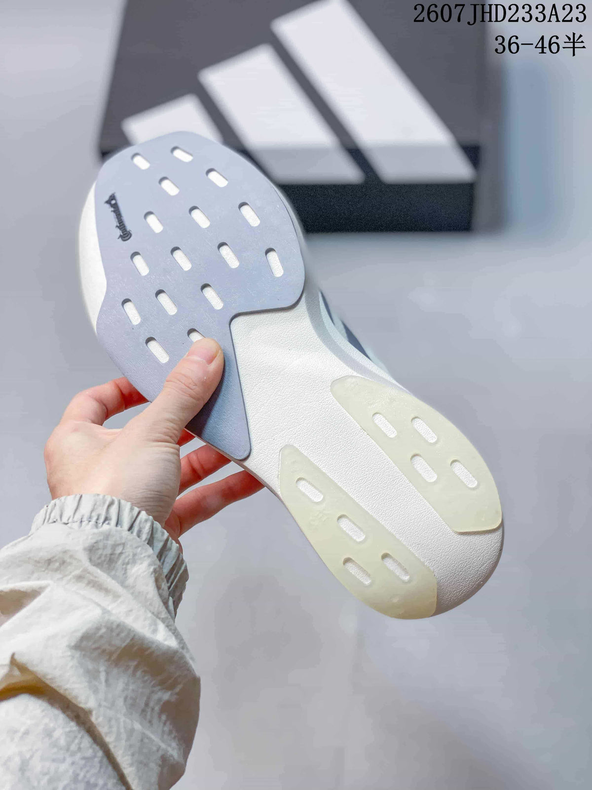Close-up of the sneaker outsole showing contrasting gray and translucent sections with elongated cutout details.