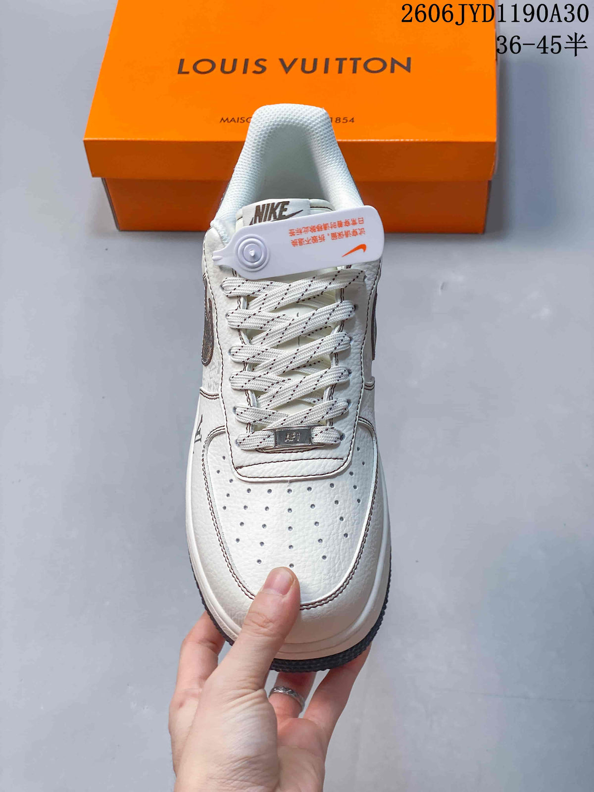 Front view showing the perforated toe, patterned laces, and cream upper.