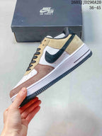 Side view of the sneaker showing layered beige, pink, and white panels, a black Swoosh, and a white midsole.