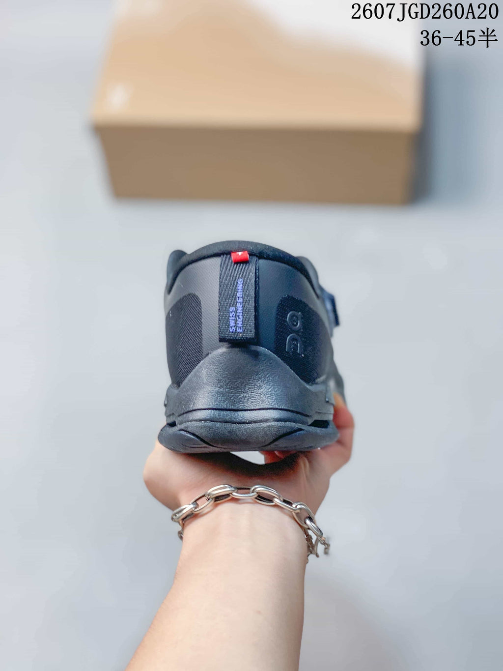 Rear view of the dark navy sneaker showing the padded heel collar, heel counter and pull tab.