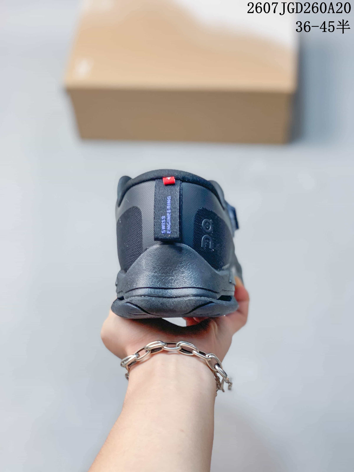 Rear view of the dark navy sneaker showing the padded heel collar, heel counter and pull tab.