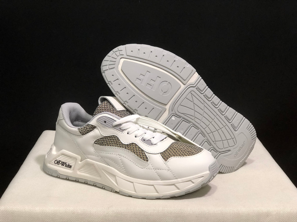 Angled view of one sneaker with the patterned outsole visible.