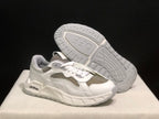 Angled view of one sneaker with the patterned outsole visible.
