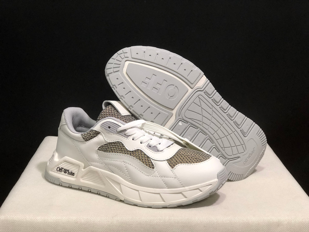 Angled view of one sneaker with the patterned outsole visible.
