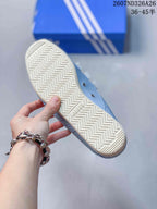 Close view of the cream-colored outsole showing a repeating zigzag tread pattern and an Adidas mark.