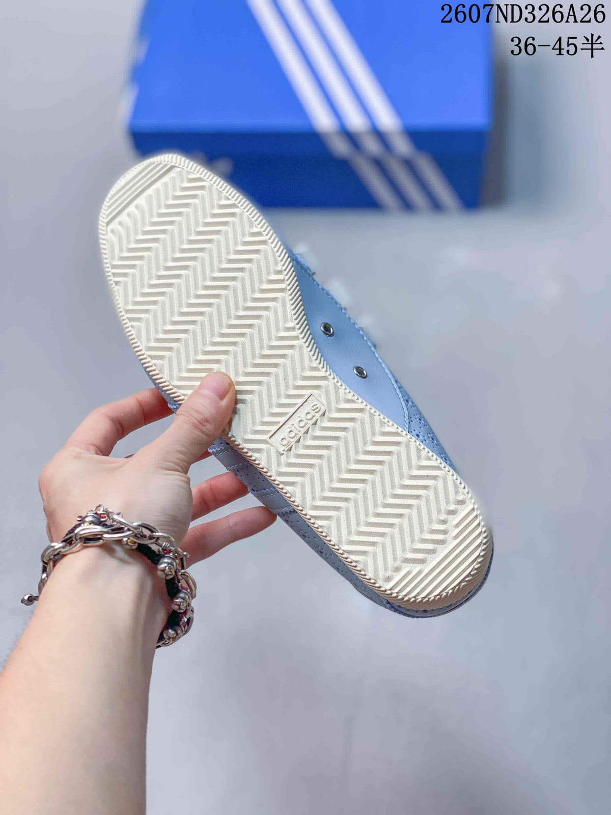 Close view of the cream-colored outsole showing a repeating zigzag tread pattern and an Adidas mark.