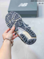 Underside view of a New Balance 1906A sneaker showing the patterned black and gray outsole and heel section.
