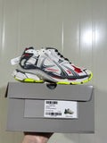 Balenciaga Runner sneaker in white, grey, black, red and fluorescent yellow shown on its box; the box label shows size C 38.