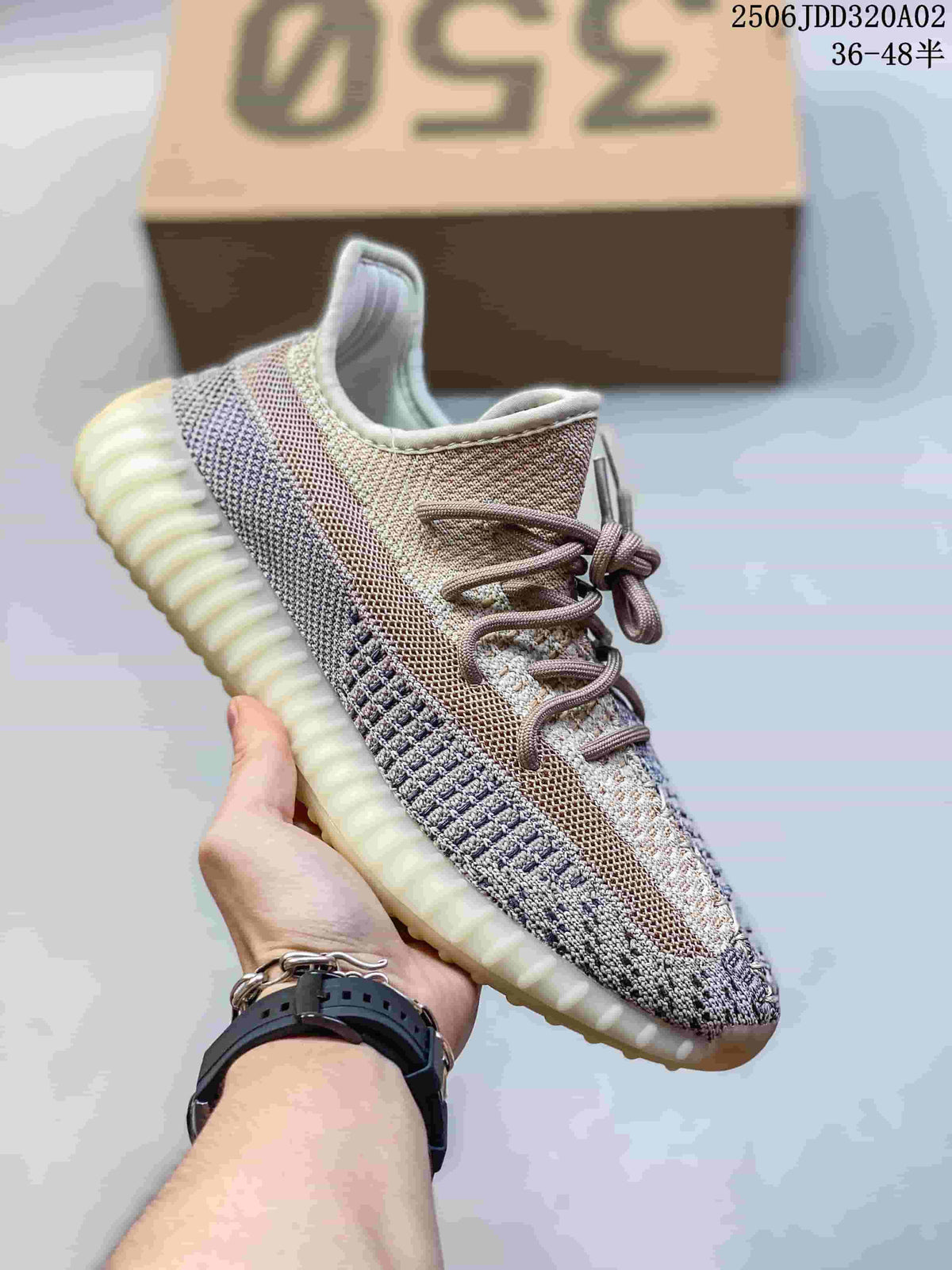 Light beige and gray knit sneaker with a pale contrasting stripe, brown laces, and a light ribbed sole.