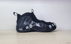 Side profile of a black high-top sneaker with white brushstroke graphics