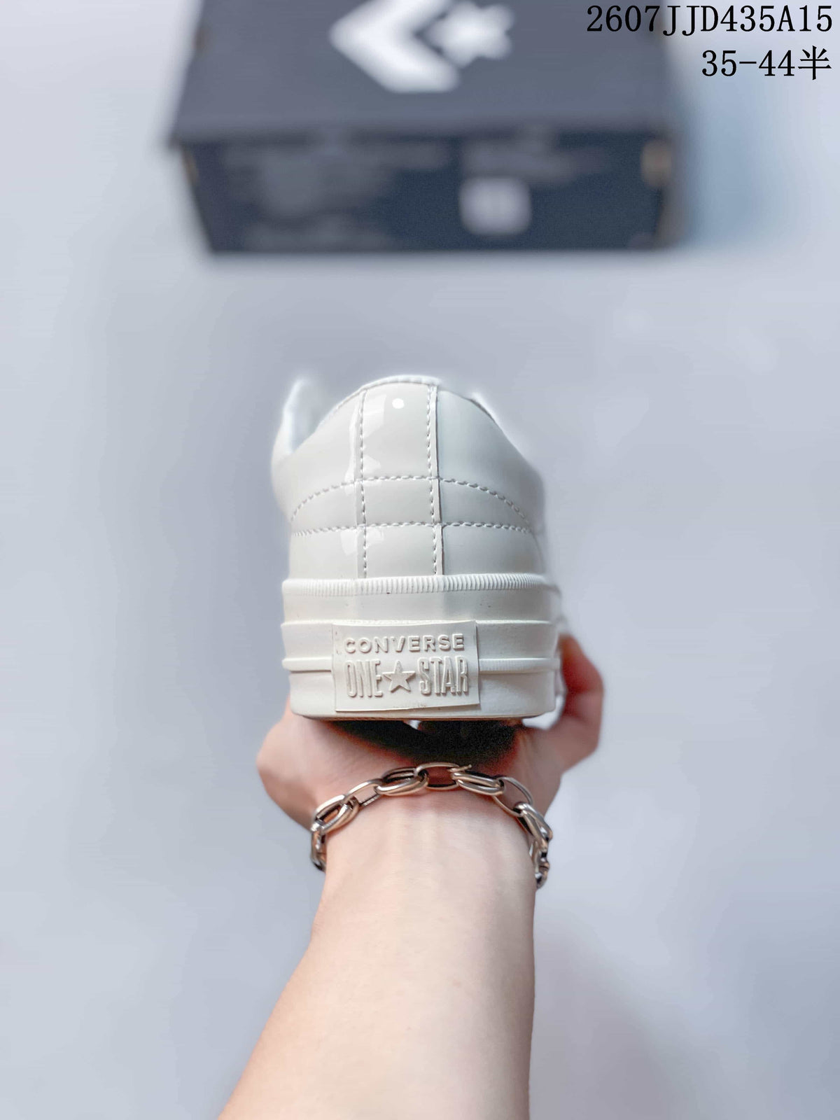 Rear view of the white sneaker showing the embossed Converse One Star heel detail.